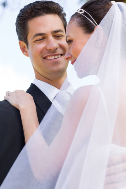 istock Happy groom looking at bride 691221050