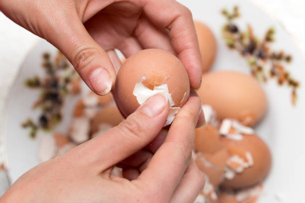 istock The girl is cleaning the egg with her hands 691222956