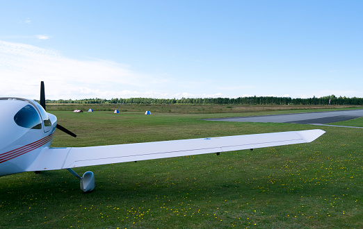 Modern four-seat airplane on the main apron of the small airfield on Laesoe island
