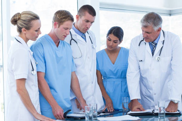 istock Team of doctors looking at their diaries 691229056