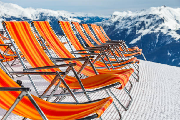 Ski resort deckchairs Photo of empty red deckchairs on the mountain in the Alps apres ski stock pictures, royalty-free photos & images