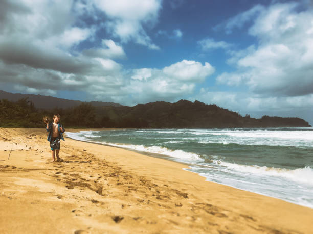 istock Child holding a coconut on beach 691232586