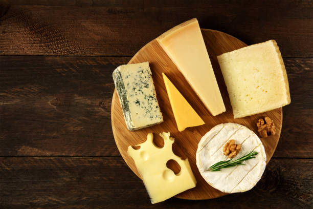 Overhead photo of selection of cheeses with copyspace stock photo