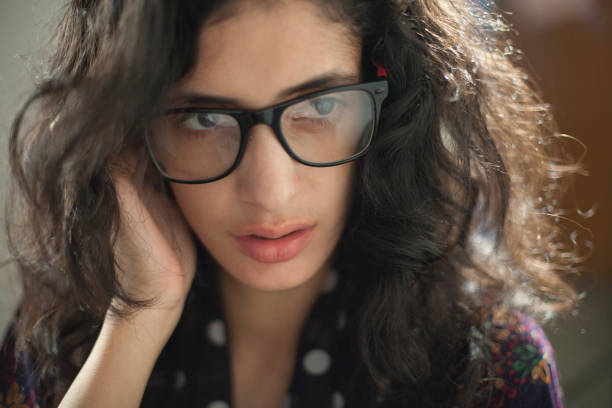 istock Confused young woman thinking while her hand in messy hair. 691235636