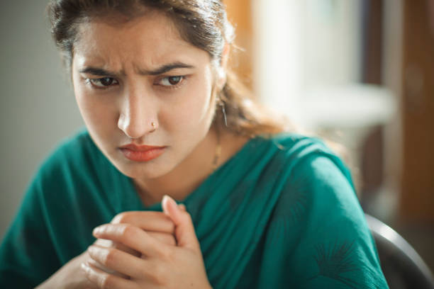 istock Confused and doubtful young woman thinking. 691235640