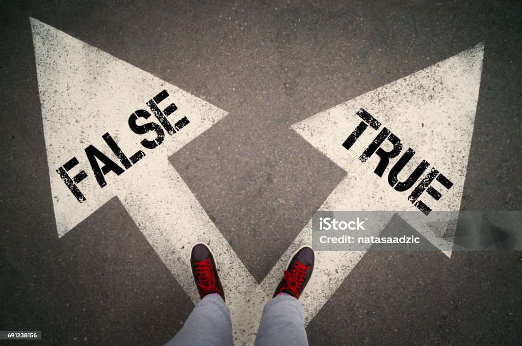 True or false TRUE versus FALSE written on the white arrows, dilemmas concept. Dishonesty Stock Photo