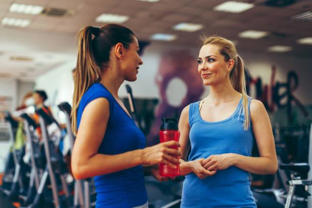 istock Two young women talking in a gym during a break 691238304