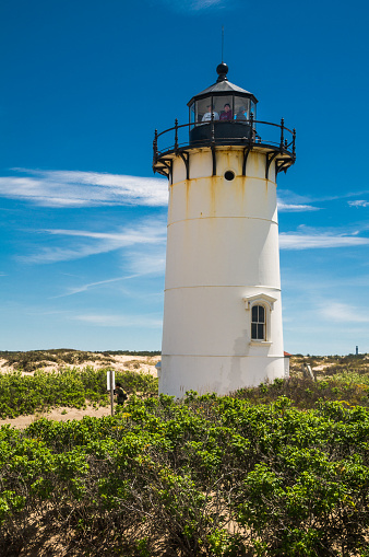 Provincetown, Massachusetts, USA -May 21, 2017- Visitors to the Race Point Lighthouse lamproom are offered majestic and far reaching views over the desolate sand dunes of Provincetown and the waters of Cape Cod Bay.