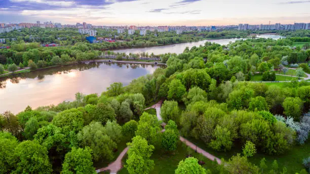 Aerial view of Tsritsyno lake - Moscow city in Russia. Park. Multi-storey buildings in the background. Sunset. Urban view.