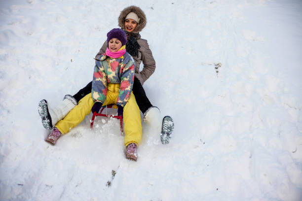 istock Mother and daughter enjoying sledge ride 691248606