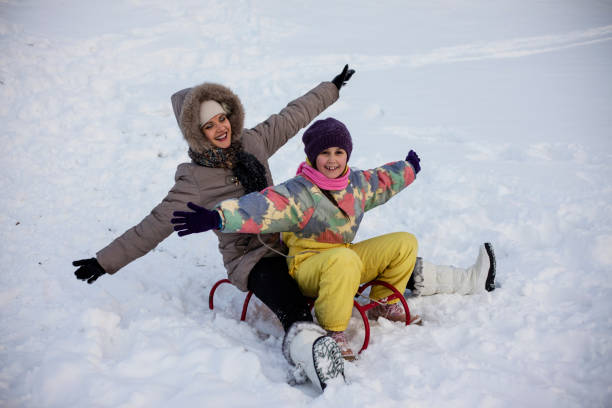 istock Mother and daughter enjoying sledge ride 691248658