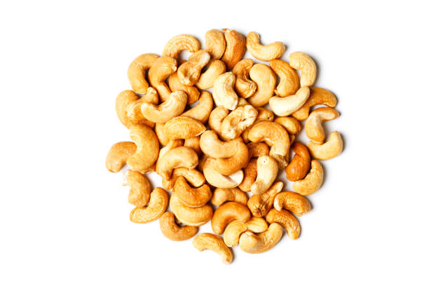 istock Heap of roasted cashew nuts on white 691248664