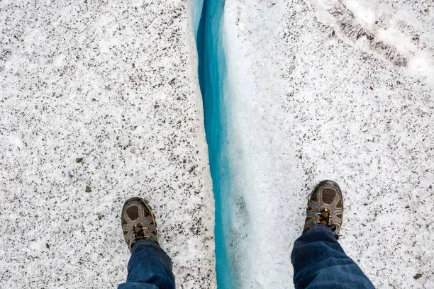 Standing over a crevice on a glacier