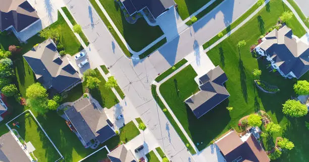 Photo of Looking down on beautiful suburban homes, Springtime aerial view.