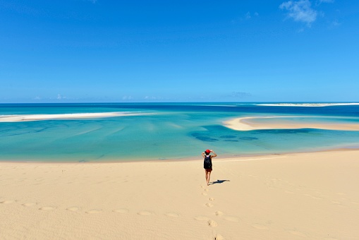 A young woman is in awe with spectacular views from Bazaruto Archipelago in Mozambique, East Africa.