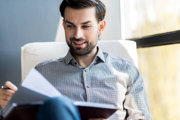 istock Cheerful bearded guy sitting in chair 691261922