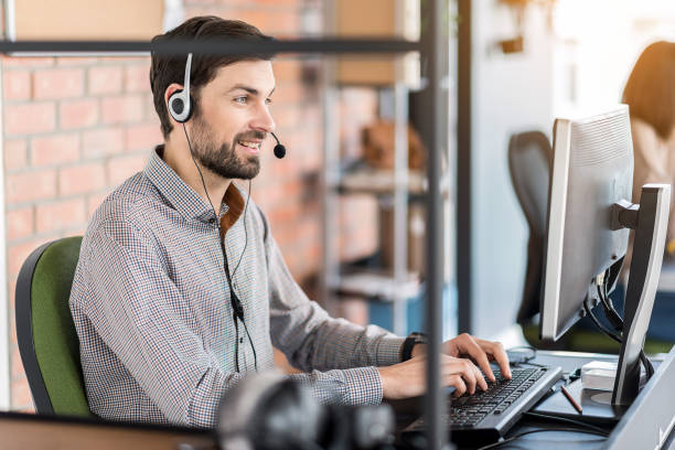 istock Positive pleasant guy sitting at table in office 691265798