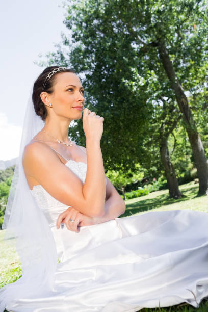 istock Young bride sitting in garden 691275980