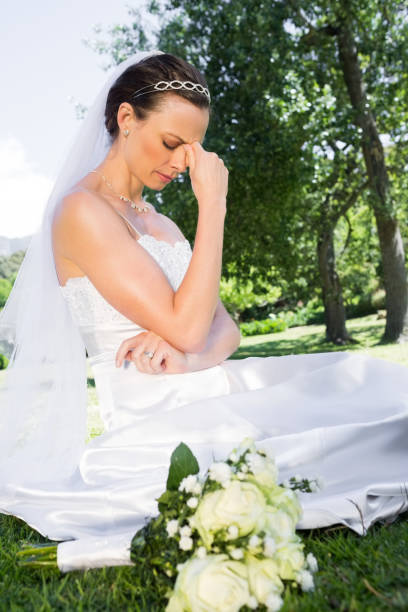 istock Depressed bride sitting in garden 691275986