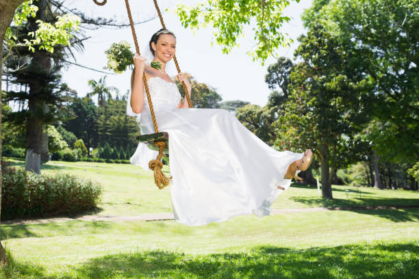 istock Young bride swinging in garden 691276362