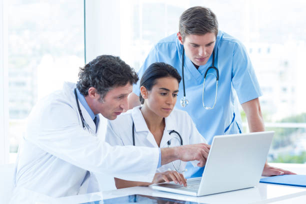 istock Team of doctors working on laptop 691291066