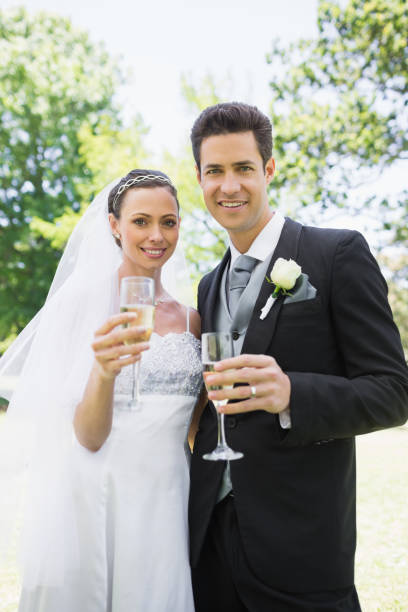 istock Bride and groom toasting champagne 691294598