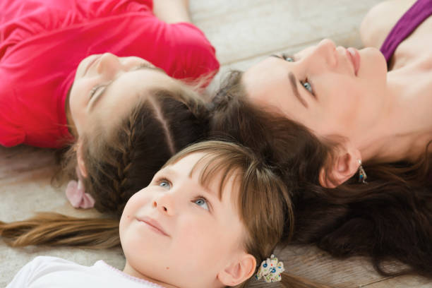 istock Young mother and daughter lying on the floor 691294784