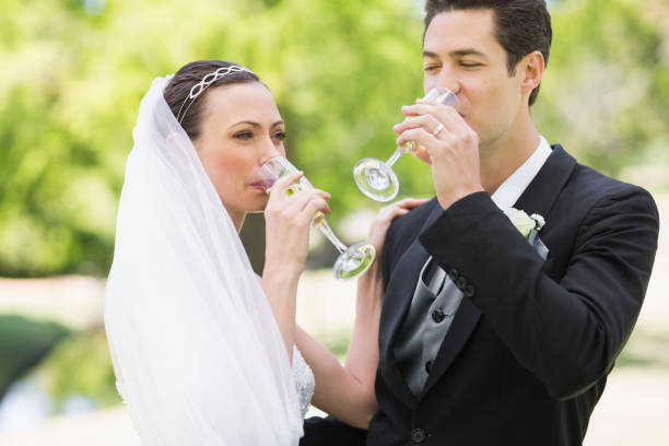 istock Newlywed couple drinking champagne 691296896