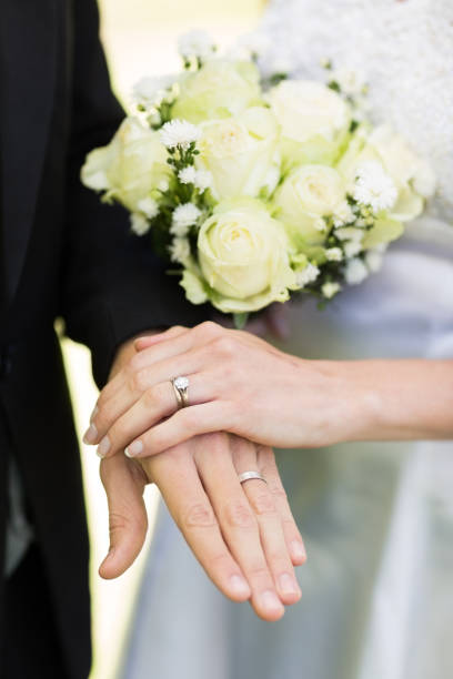 istock Bride and groom showing wedding rings 691297210