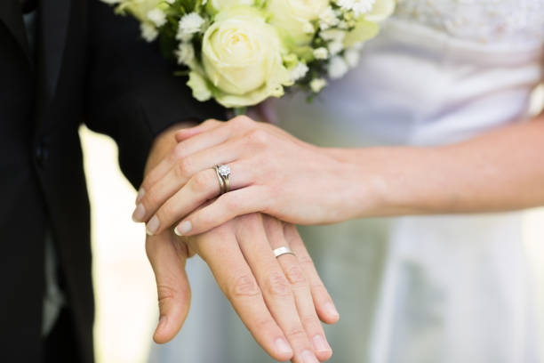 istock Bride and groom showing wedding rings 691297216