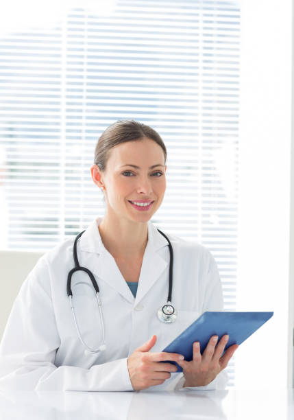 istock Beautiful female doctor holding digital tablet 691297504