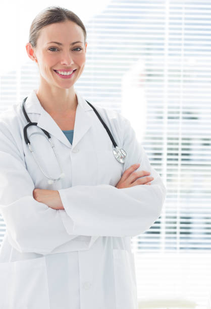 istock Confident female doctor standing arms crossed 691297536