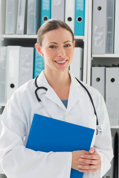 istock Beautiful female doctor holding folder 691297552