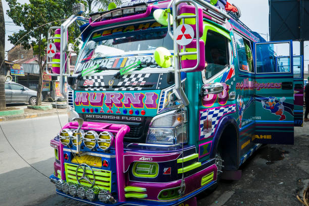 Medan: traditional vibrant bus waiting for passengers at minibus station.