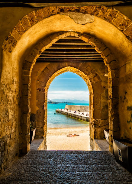 Cafalu Sicily - Archway to Beach.jpg Archway through an ancient stone building leading to a beach with unrecognizable people in Cefalu, Sicily, Italy sicily stock pictures, royalty-free photos & images