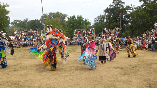Ohsweken, Ontario, Canada - July 24, 2016 Six Nations Turtle Island powwow gate opening. The Grand Entry. Dancers carry with pride and dignity. Mobile photo.