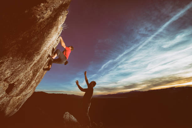 istock Climbing in the sunset with friend 691315880
