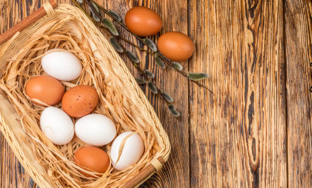 istock White and brown eggs in the basket on the table. Easter 691318154