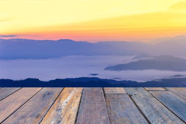 istock Skyline with mist and mountain with wooden floor perspective. 691318562