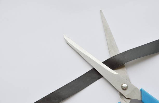 istock scissors blade cutting black cloth ribbon 691320300