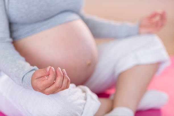 istock Pregnant woman doing yoga on exercise mat 691323504