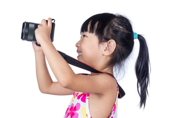 Asian Little Chinese girl holding a camera in isolated white background