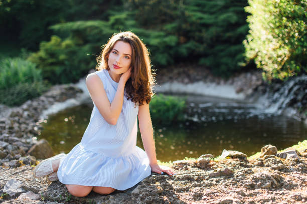 istock Pretty girl pose to camera at park with sunlight background 691327500