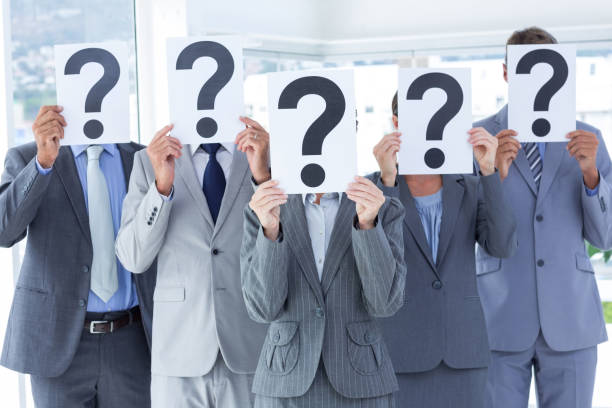 istock Business colleagues hiding their face with question mark sign 691330648