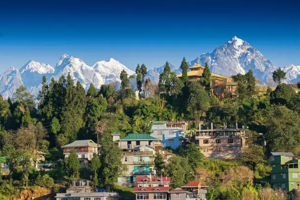 Mount Pandim (right), Mount North kabru (middle) and Mount South Kabru (left) Himalayan Mountain range - with top of Rinchenpong town in foreground, clear blue sky above. Rinchenpong, Sikkim, India