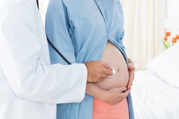 istock Doctor checking expectant woman 691338346