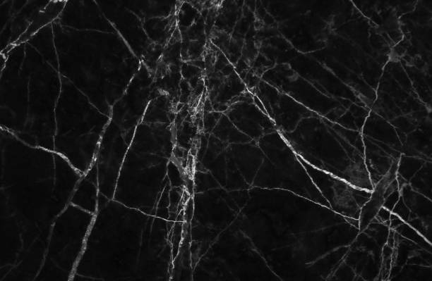 istock Black and dark marble texture shot through with white deep veining 691341322
