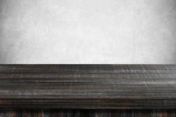 istock Empty dark wooden table over gray cement wall, vintage, background, template, product display montage 691346496
