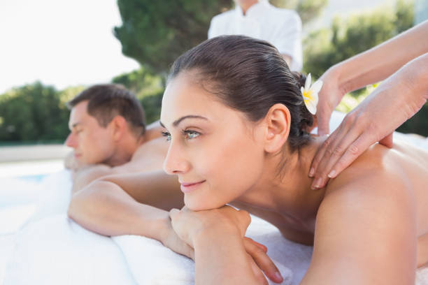 istock Attractive couple enjoying couples massage poolside 691350060