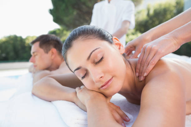 istock Attractive couple enjoying couples massage poolside 691350078